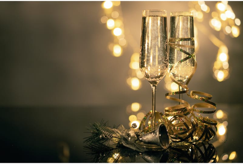2 glasses of Champagne covered in festive decoration