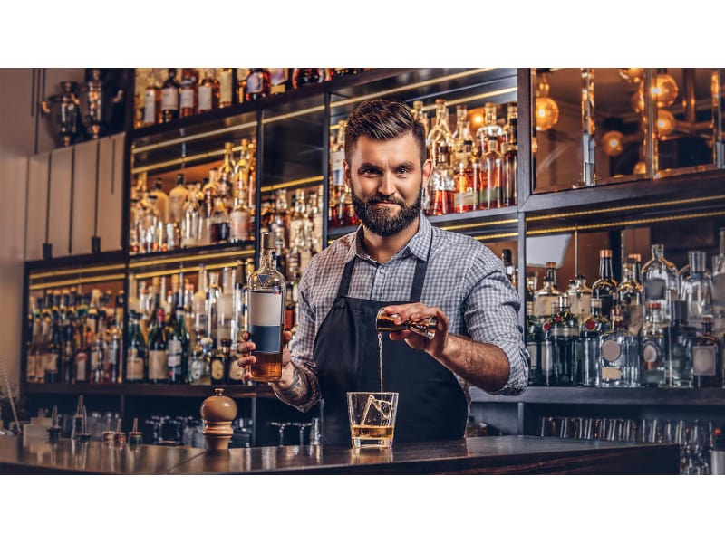 a bartender smiling in a bar