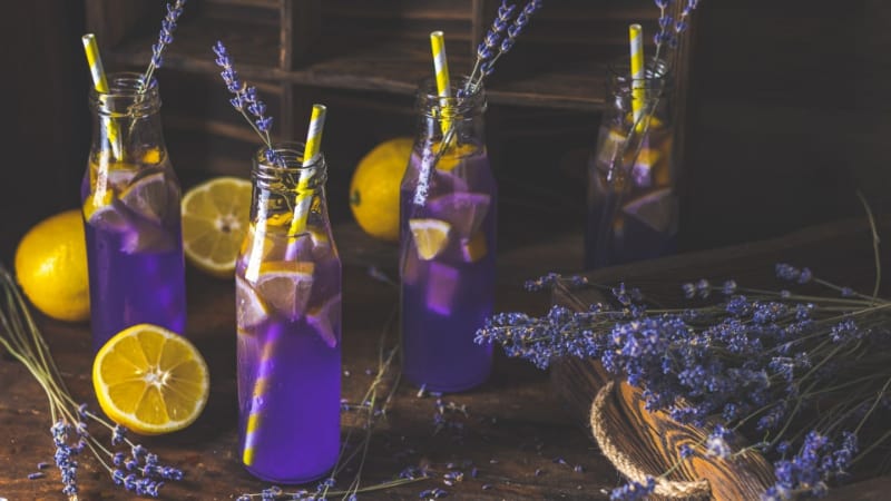 4 bottles of energized purple rain with lemon and straws