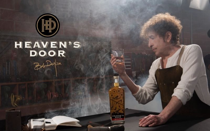 Bob Dylan holding a glass of Heaven’s Door whiskey - Image by rollingstone.com