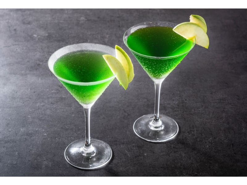 Two glasses of Appletini mocktail with a lime garnish