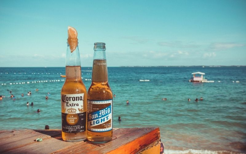 A bottle of a light beer and a regular beer