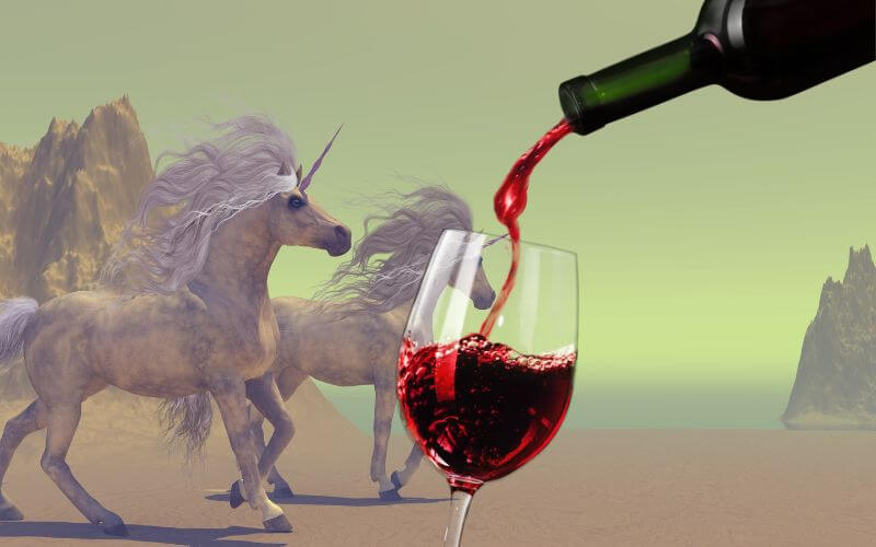 A bottle of wine with unicorns in the background