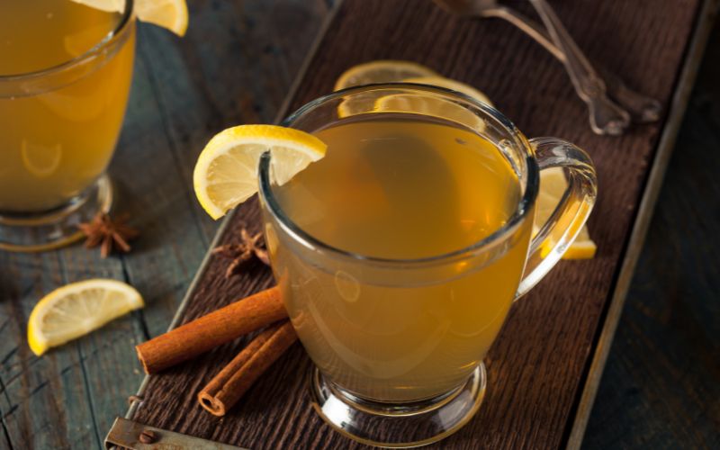 A cup of hot bourbon toddy with spices