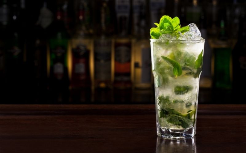 A glass of Classic Mojito on bar counter