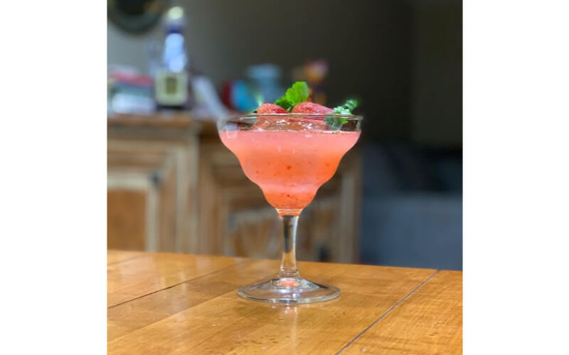 A glass of Strawberry Cilantro Margarita