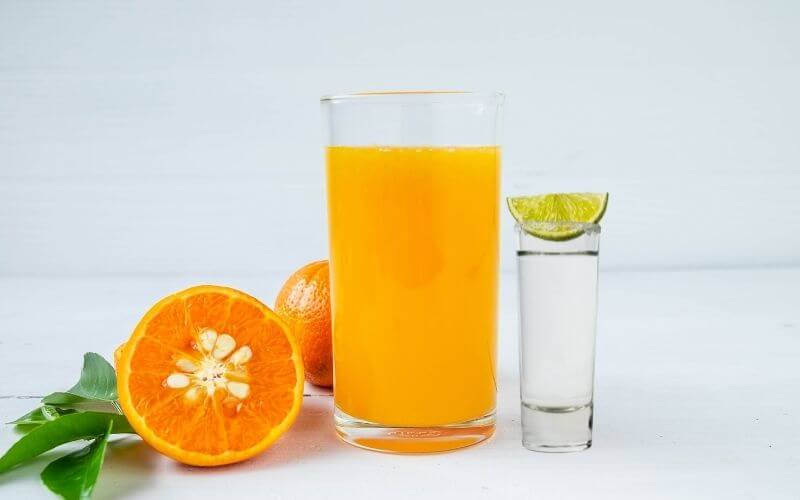 A glass of Orange Tic-Tac Bomb