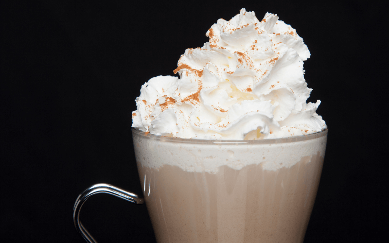 A glass of copycat maple pecan latte in a dark background