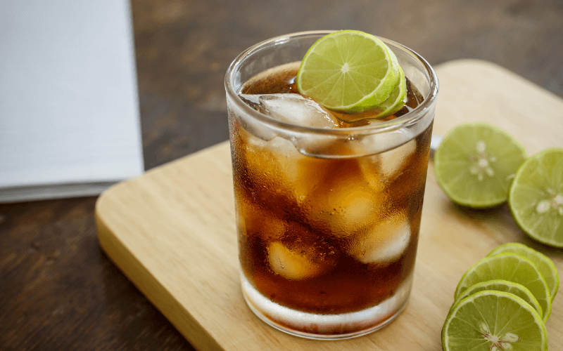 A glass of lime cola in a wooden background