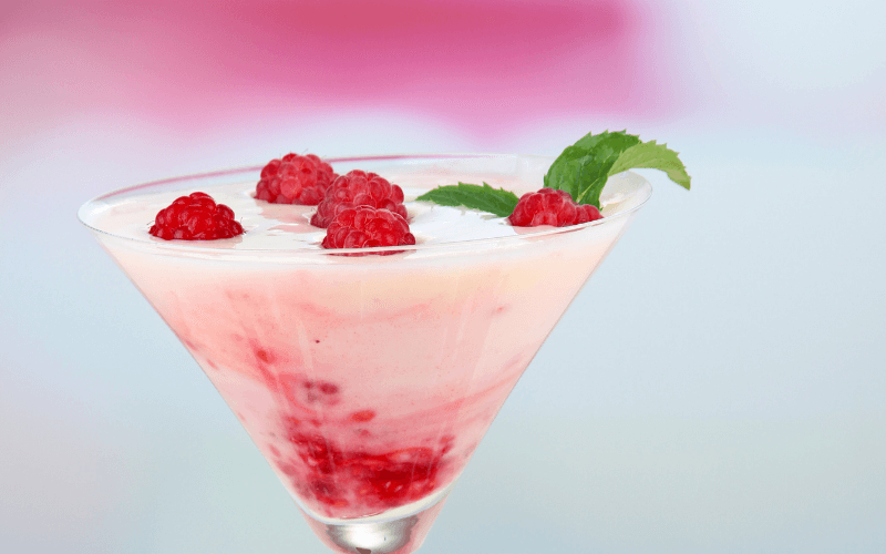 A glass of raspberry russian cocktail in a light background