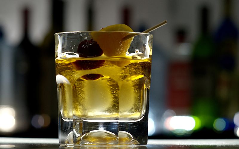 A glass of winter-spiced old-fashioned cocktail