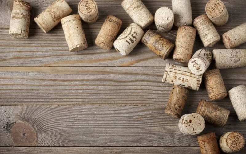Assorted wine corks on a wooden background