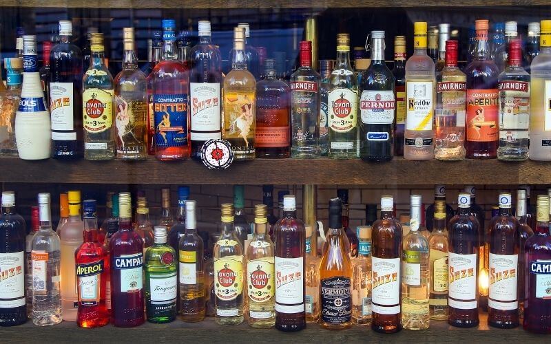 Bar shelves fully stocked with liquors and spirits