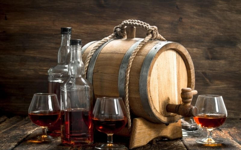 Barrel with a bottle and glasses of cognac