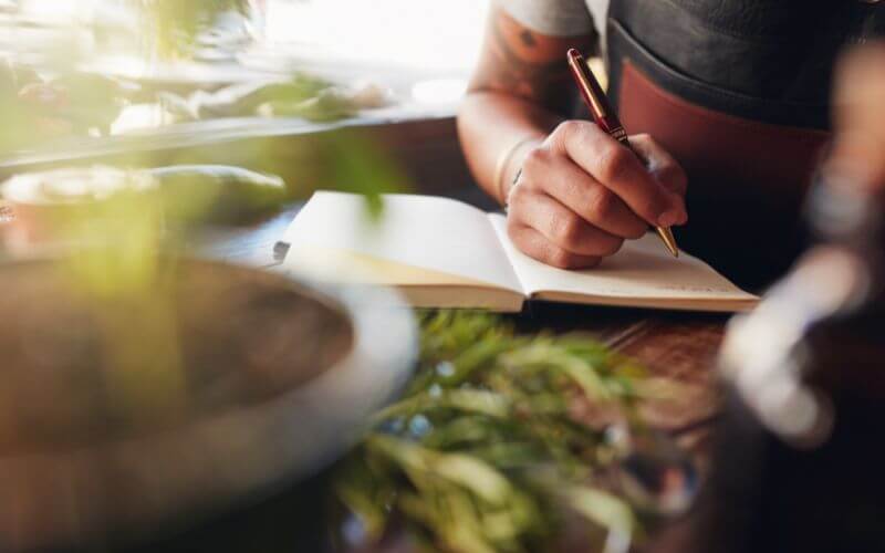 Bartender writing new cocktail ideas