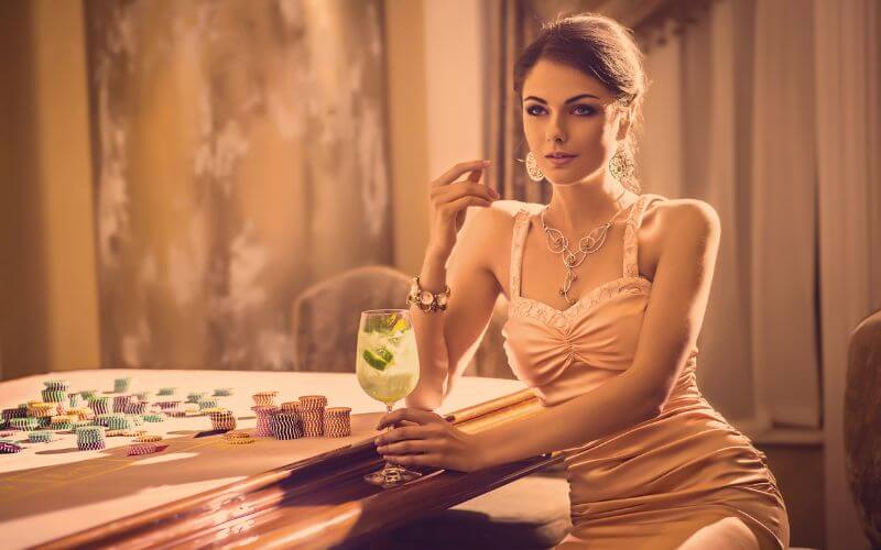 Beautiful woman sitting and holding a cocktail