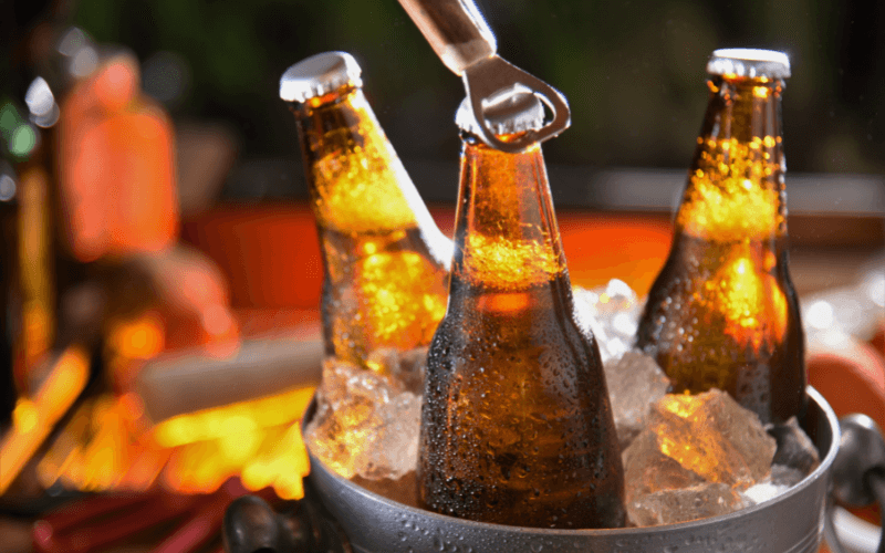 Beer bottles in an ice bucket with opener