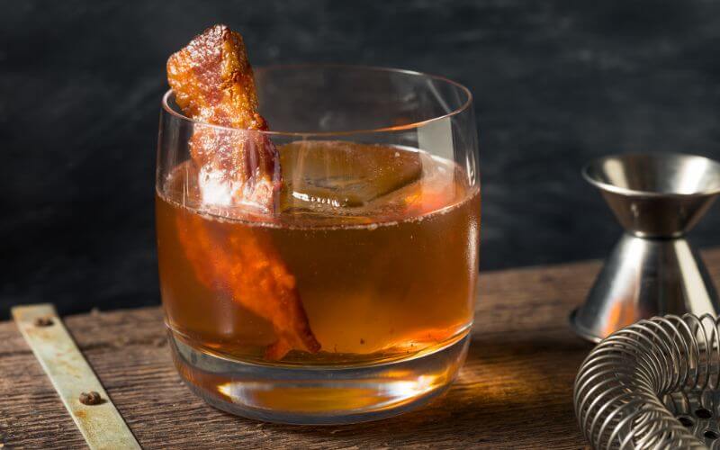 Beer cocktail with bacon as garnish