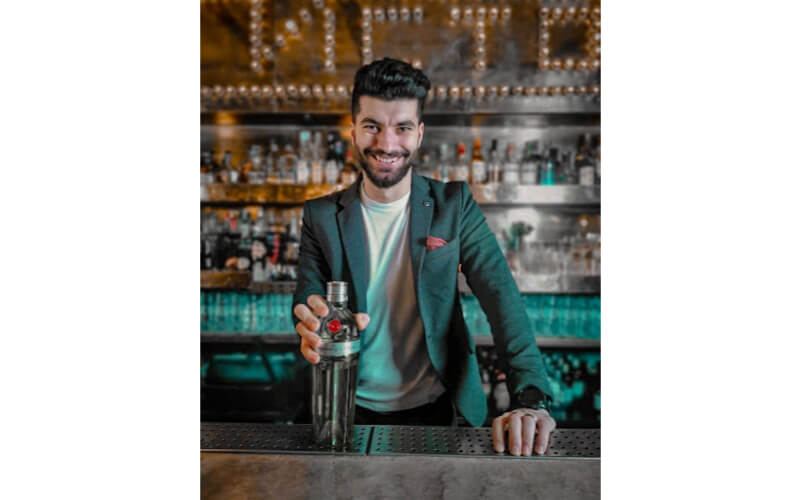 Bertalan Andrei behind a bar