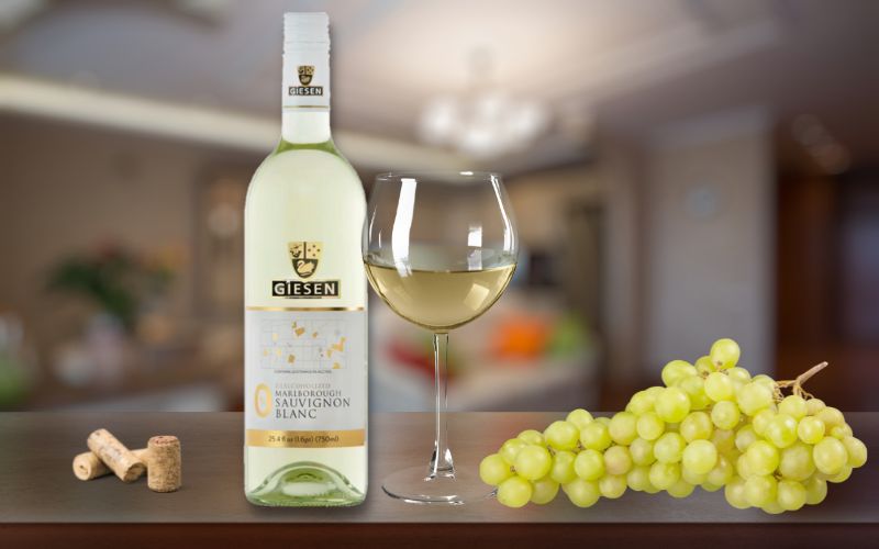 Bottle and glass of Giesen wine with grapes and corks