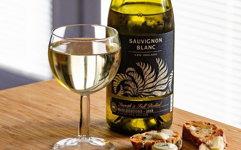 Bottle and glass of Sauvignon Blanc With Slices of Cheese