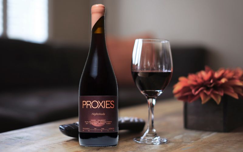 Bottle and wine of Proxies with a red plant