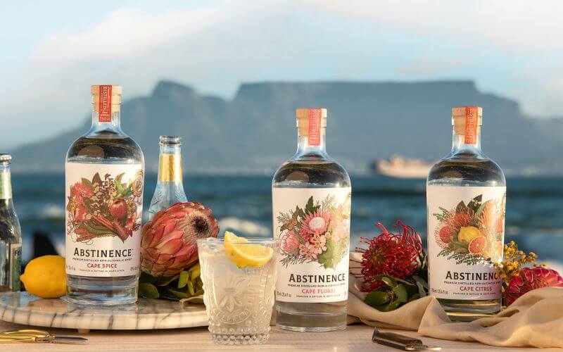 Bottles of Cape Spirits with a mocktail and flowers