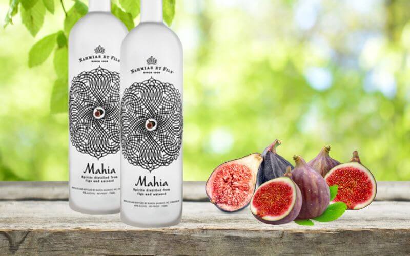 Bottles of Mahia beside figs