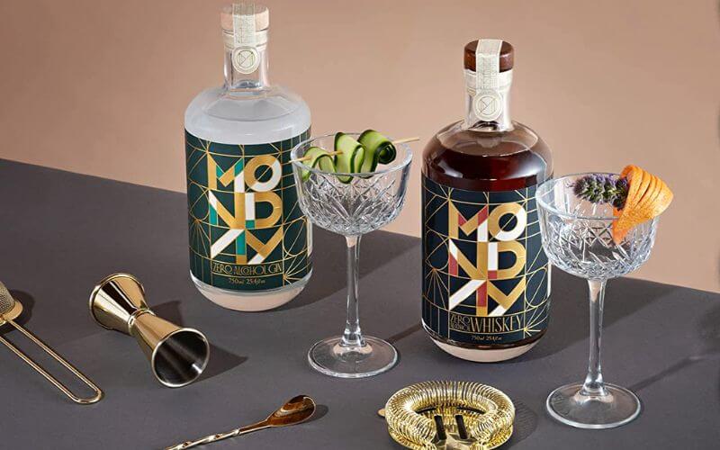 Bottles of Monday spirits with glasses and bar tools