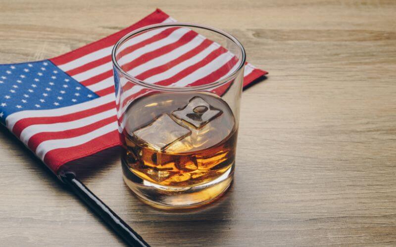 Bourbon whiskey beside the American flag