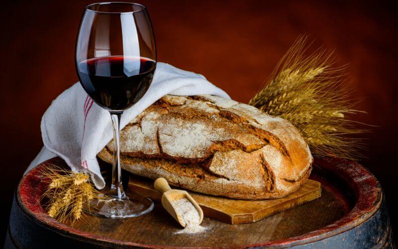 Bread on a barrel with a glass of wine