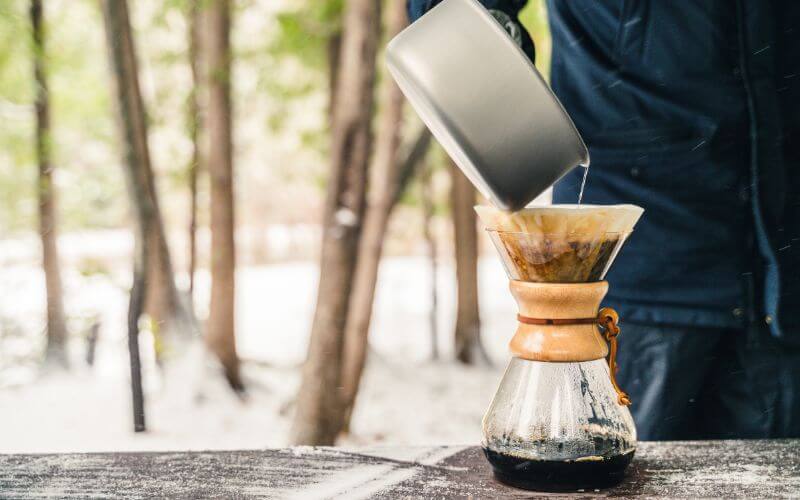 Camper brewing coffee outdoors