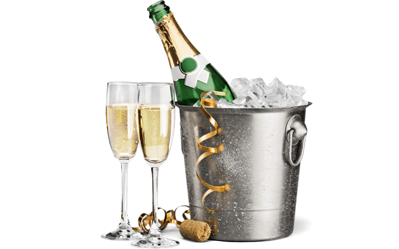 Champagne bottle in a bucket beside glasses of Champagne