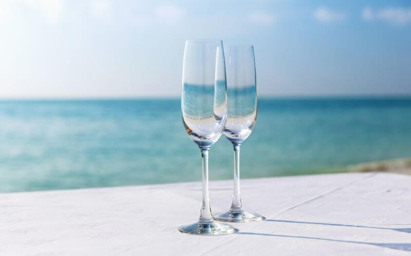 Champagne flutes by the beach