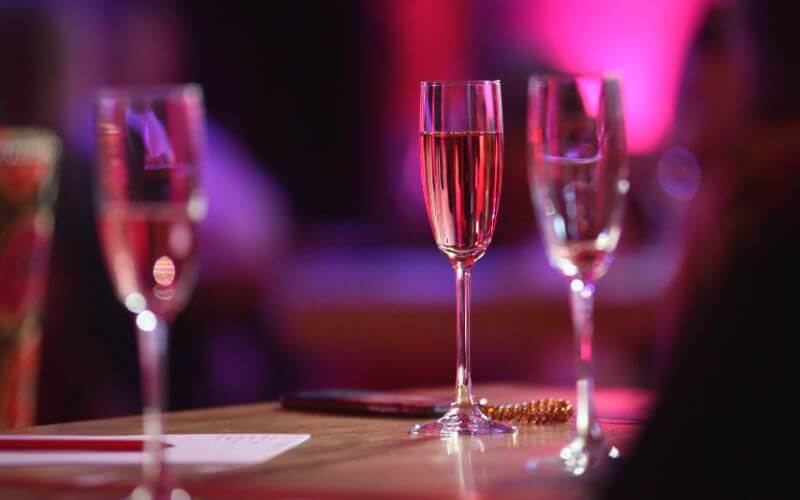 Champagne glasses in a pink setting