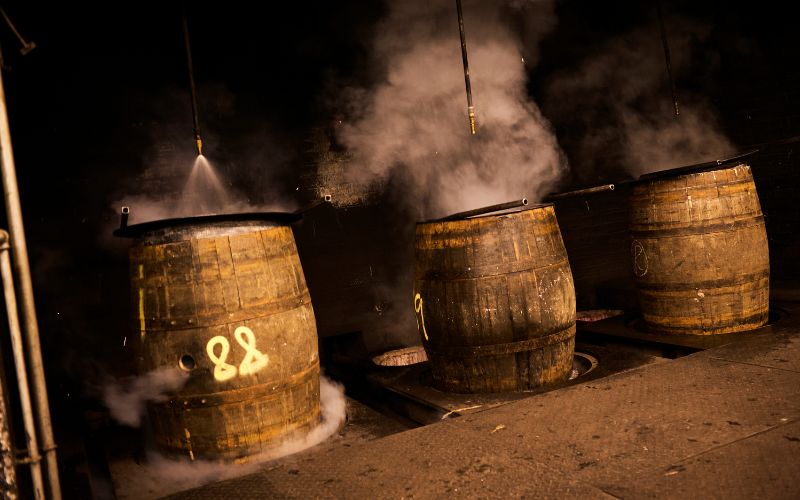 Charring whisky barrels