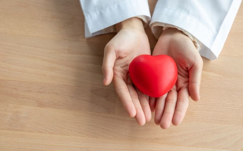 Close-up of Red Heart in the Hands of Woman