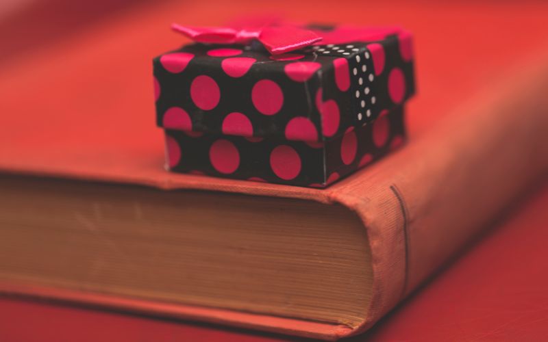 Closeup of an old book and a gift box