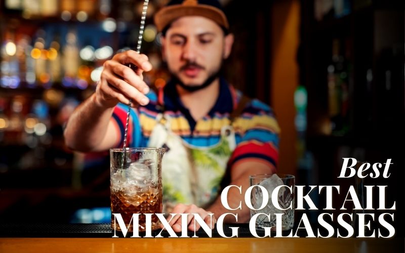 A bartender mixing a cocktail in a glass