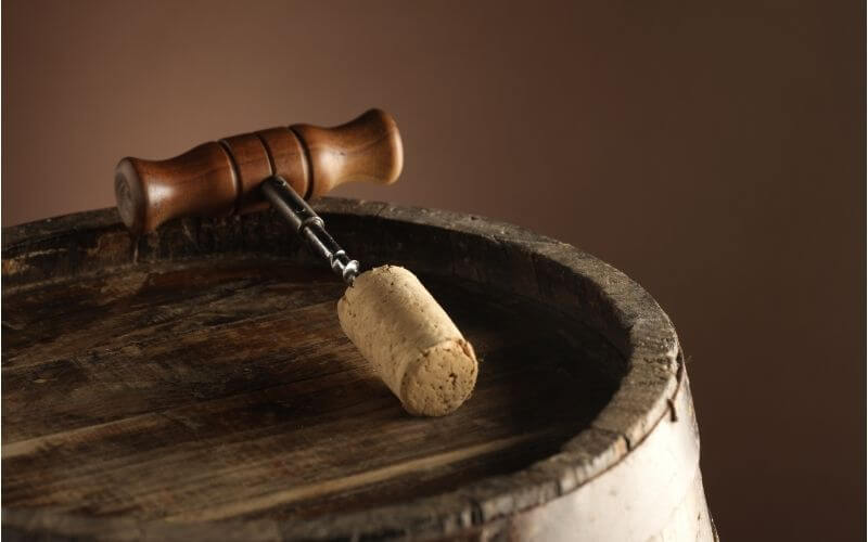 Cork attached to a corkscrew on a barrel