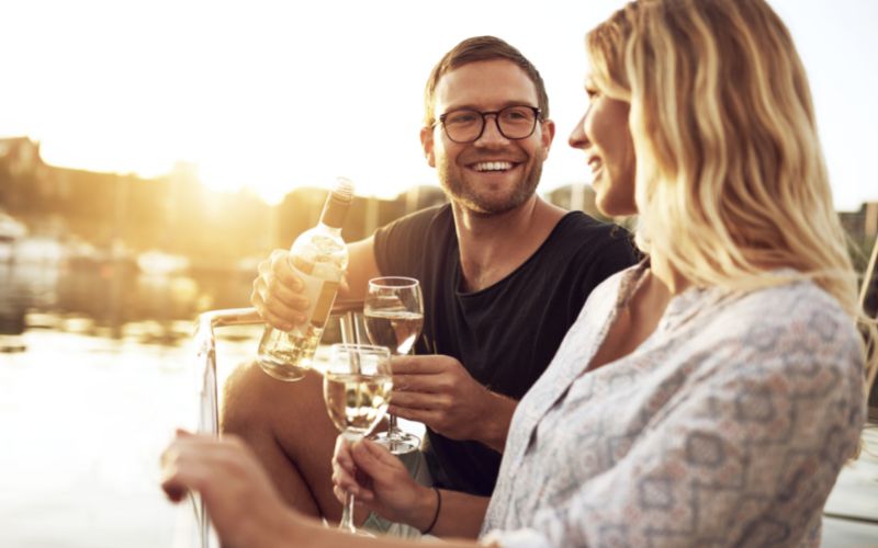 Couple drinking wine during a sunset