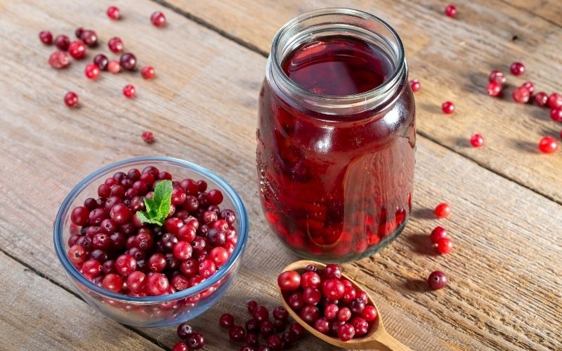 Cranberry juice with whole cranberries in a bowl