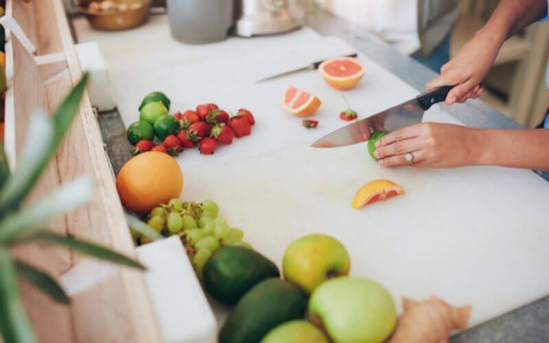 Cutting fruits on a board