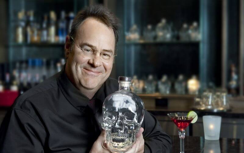 Dan Aykroyd holding up a Crystal Head vodka - Image by Total Wine