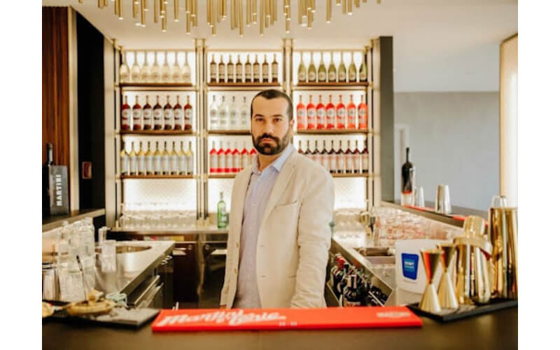 Diego Ferrari behind a bar
