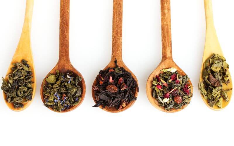 Different Varieties of Loose Leaf Tea on Wooden Spoons