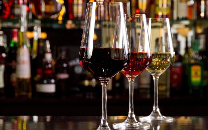 Different types of wines in glasses in a bar