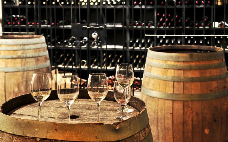 Empty wine glasses on barrels in a cellar