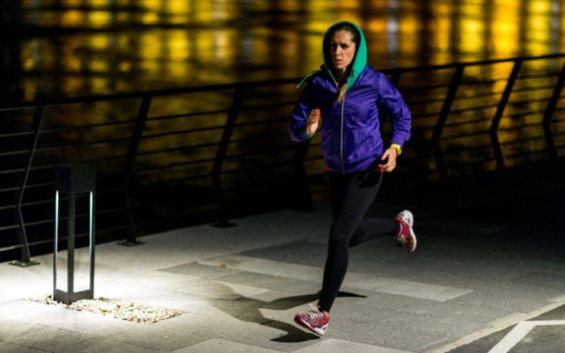 A woman jogging at night