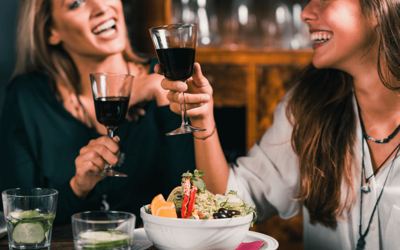 Female friends in a vegetarian restaurant drinking wine